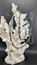 Load image into Gallery viewer, photo of fern green and gold show lead highlighting its two bead clusters